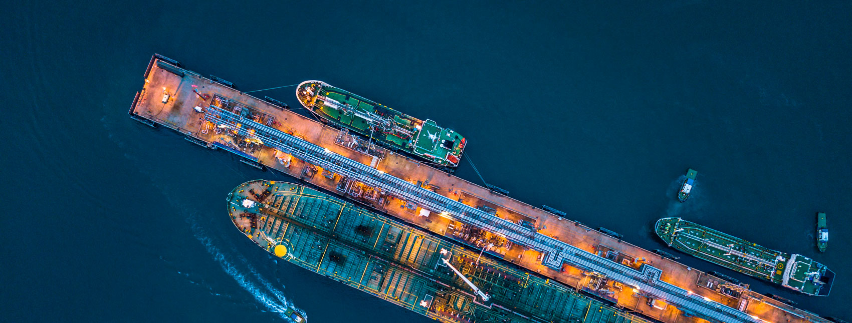 Tanker ship loading and unloading oil and gas storage at industrial port Image