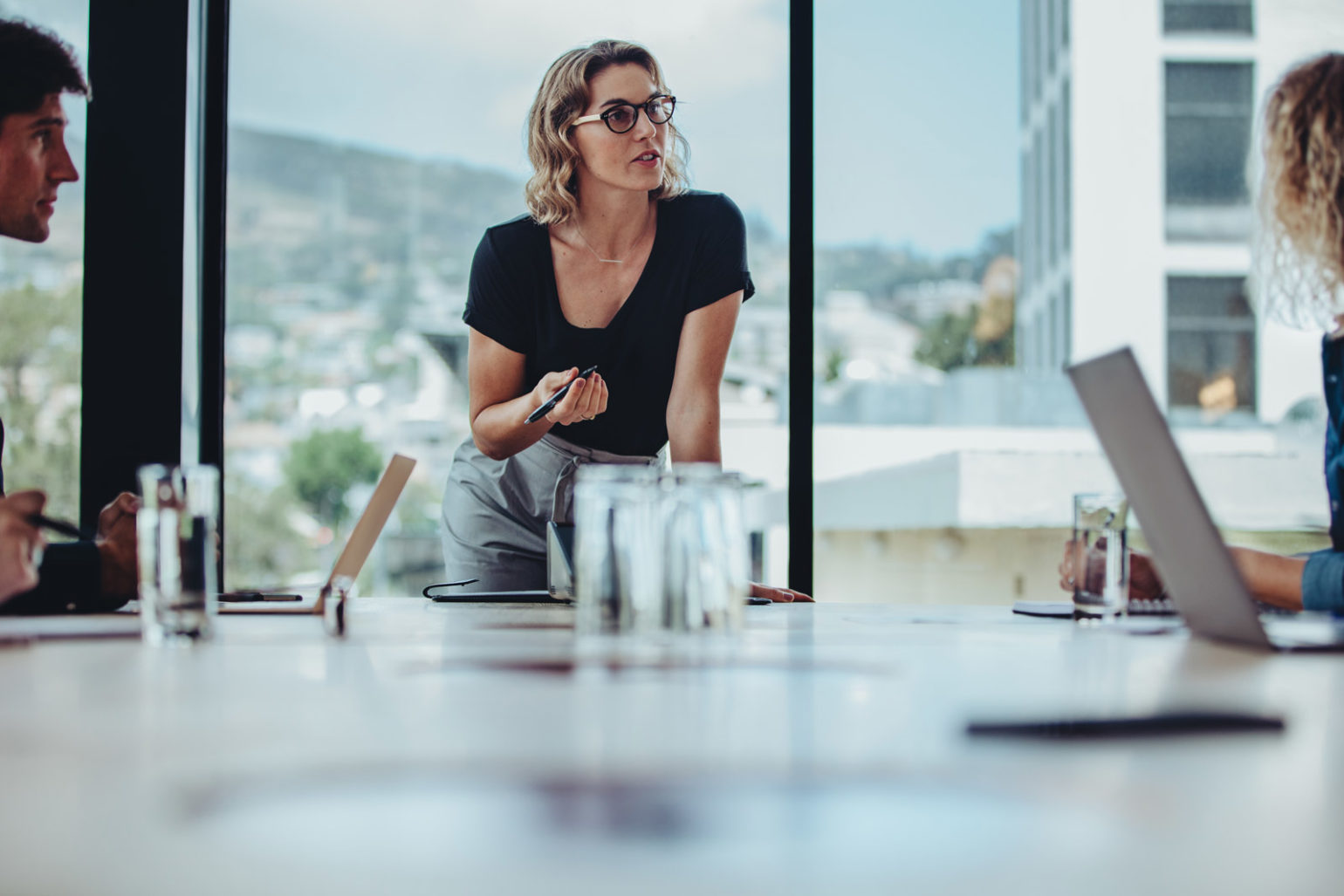 Image of a Businesswoman discussing work with coworkers in meeting