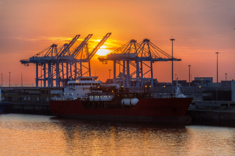 Peninsula vessel berthed at the Port of Zeebrugge during sunset.